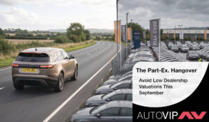 an overcrowded car dealership forecourt with a luxury SUV driving away.